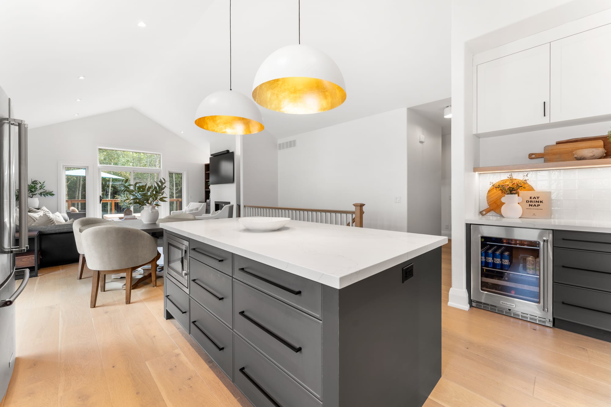 Kitchen island with built-in microwave drawer and beverage fridge, opening onto the dining area at 110 Mary Street, Collingwood