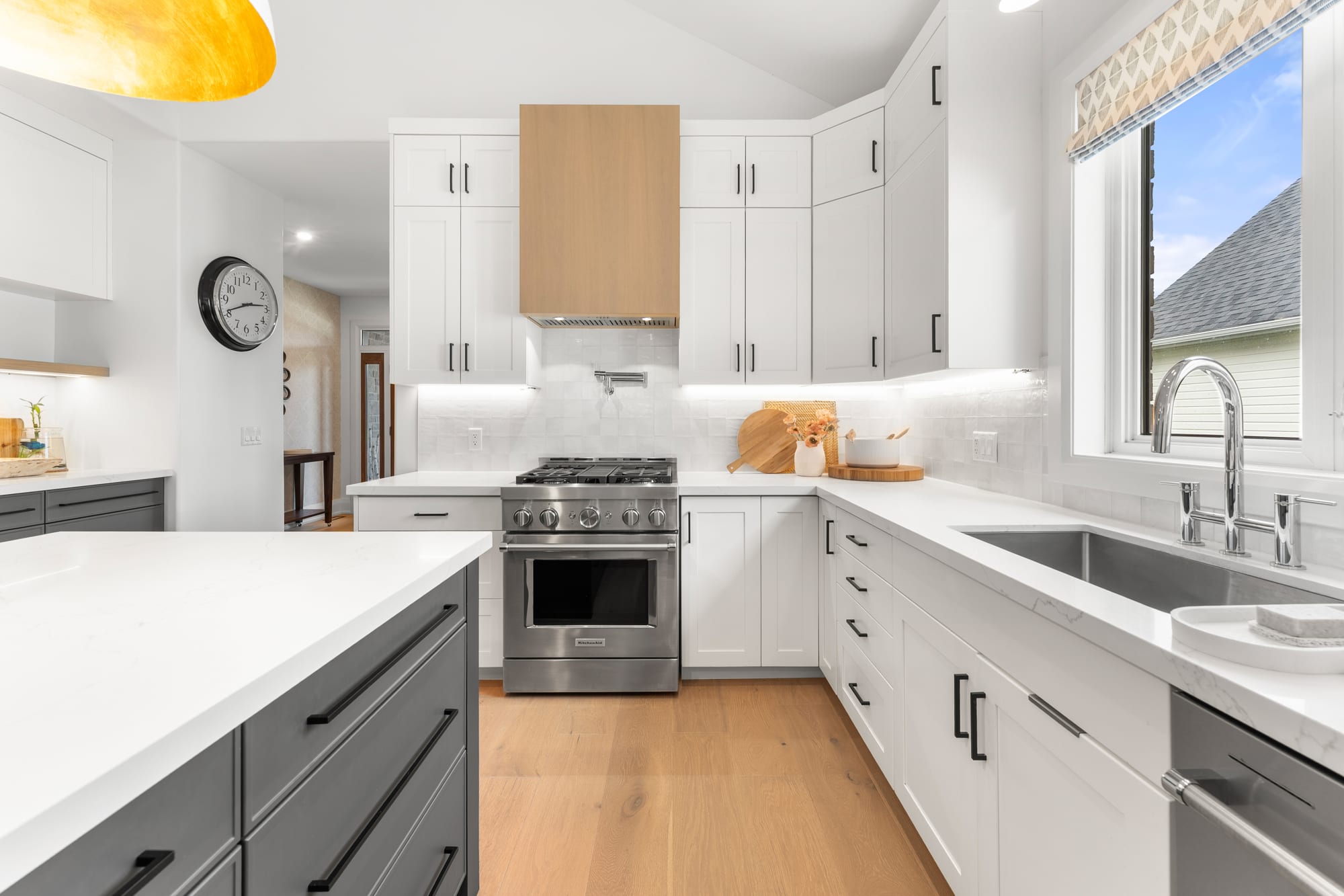 Commercial-style stainless gas range under a white oak hood with a pot filler and zellige tile backsplash, Collingwood custom kitchen