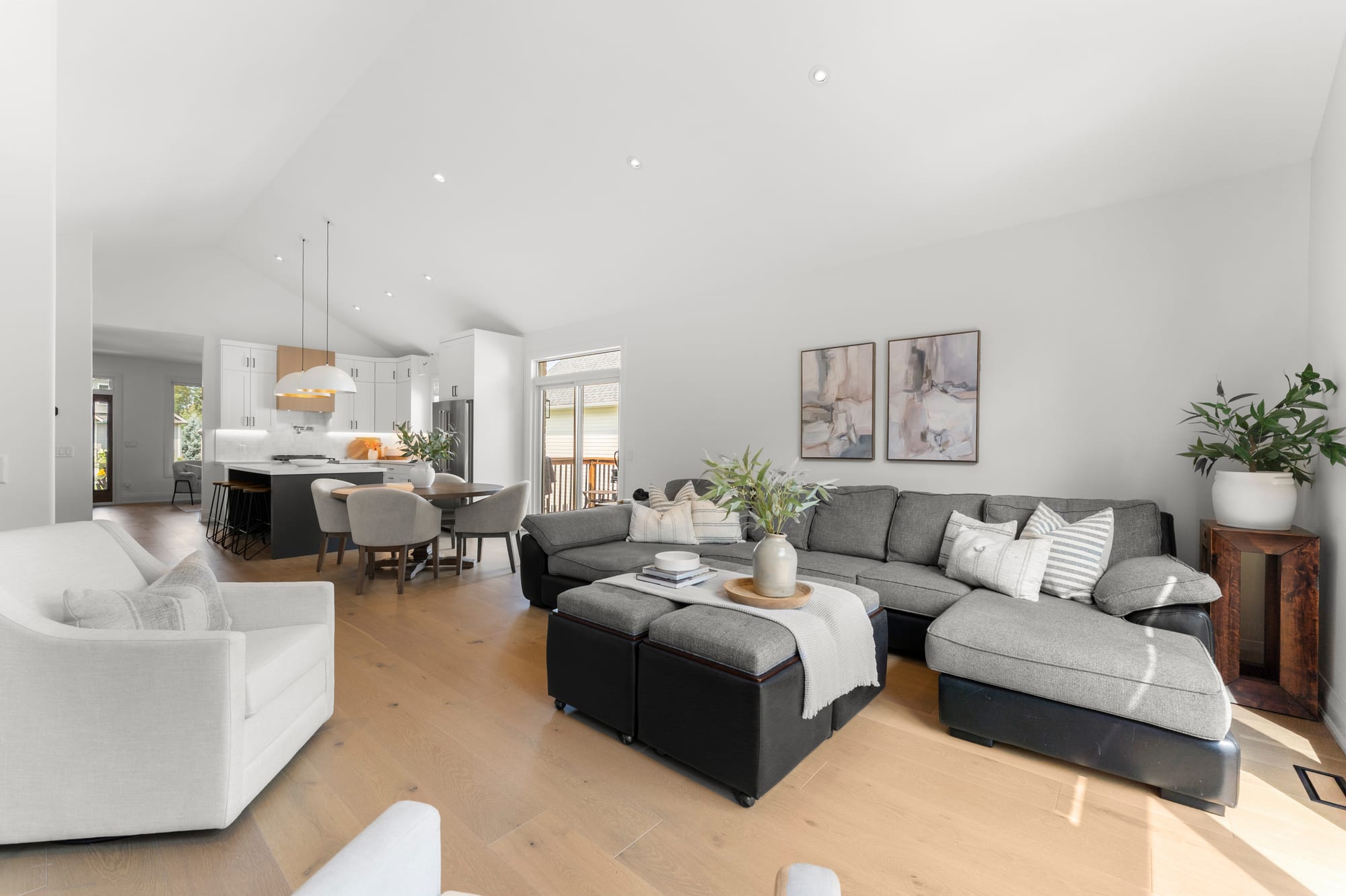 Open-concept living, dining and kitchen under a vaulted ceiling at 110 Mary Street, Collingwood, Ontario