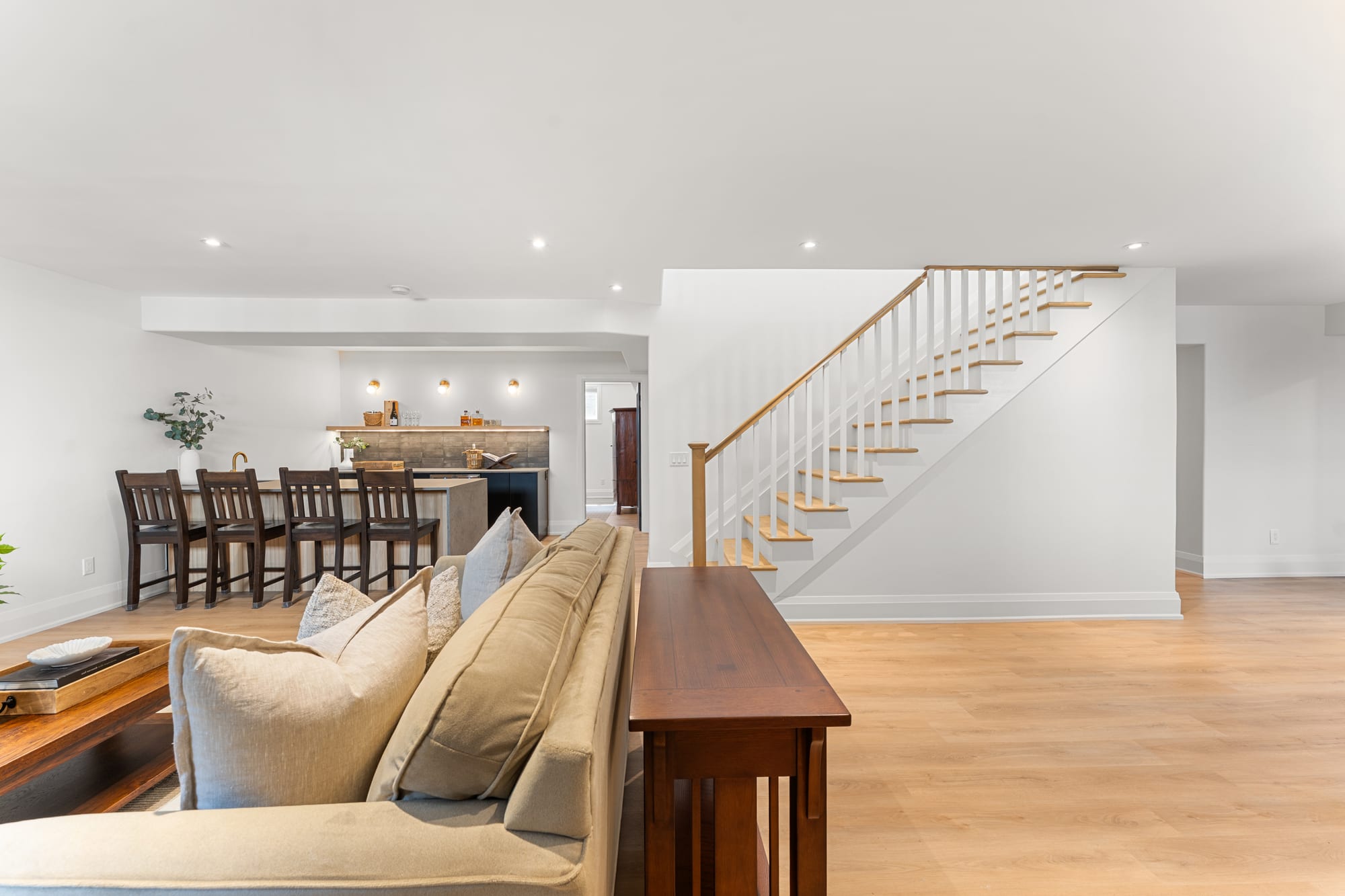 Finished lower level at 110 Mary Street, Collingwood, with a wet bar, bar seating and the staircase to the main floor