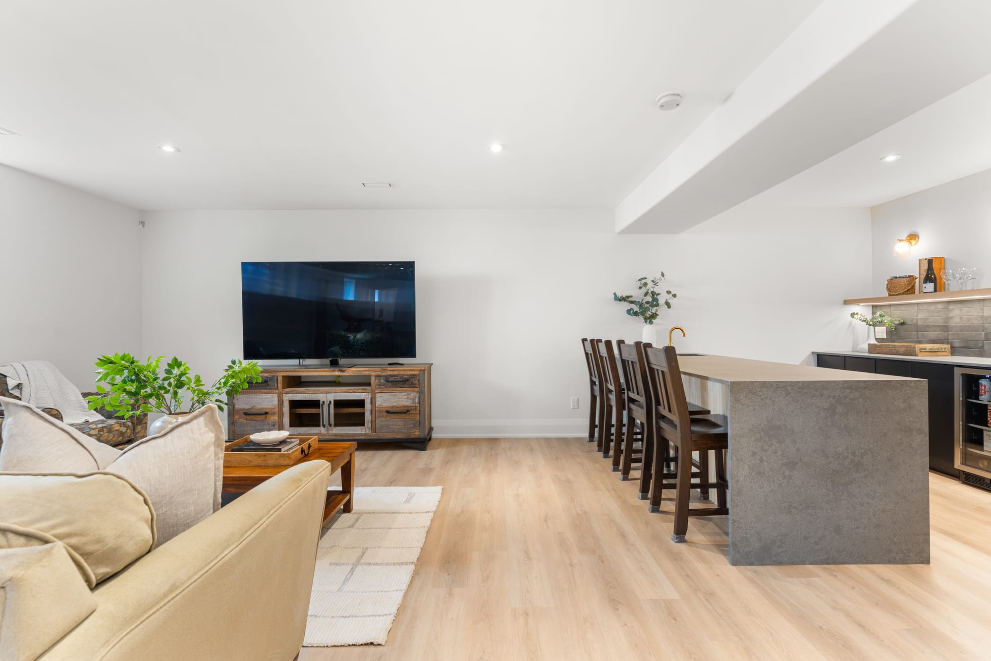 Massive lower-level rec room with television wall and bar counter seating five at 110 Mary Street, Collingwood